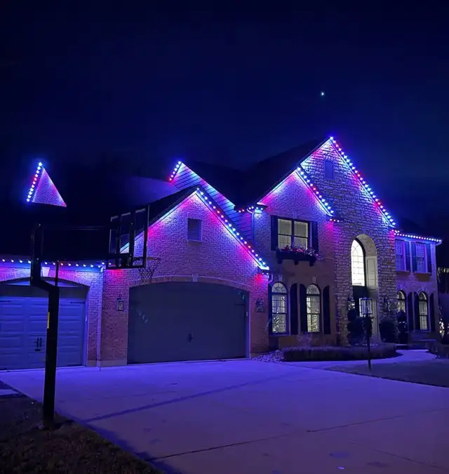 Warm white Christmas lighting outlining a two-story roofline