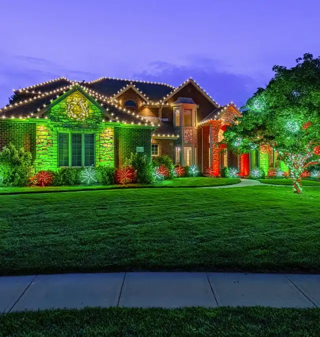 Christmas lighting on a home with red and green accent lighting